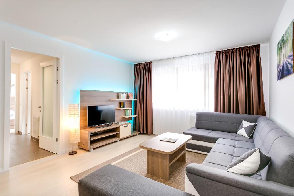 a living room with a couch and a tv at Apartment Nova Cesta 62 in Zagreb