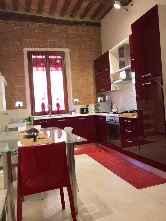 a kitchen with a table and a dining room at Nonna Anna in Siena