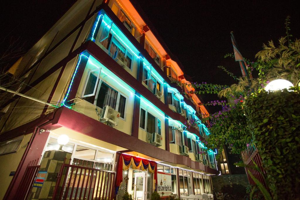 a building with blue and white lights on it at Hotel Crown Plaza in Kathmandu