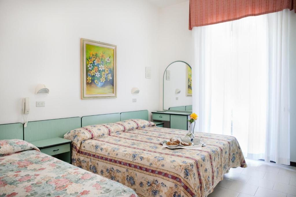 Postel nebo postele na pokoji v ubytování Hotel Villa Gori