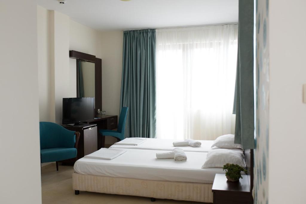 Postel nebo postele na pokoji v ubytování Ema Hotel