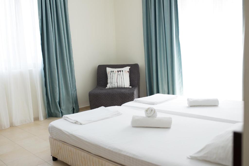 Postel nebo postele na pokoji v ubytování Ema Hotel