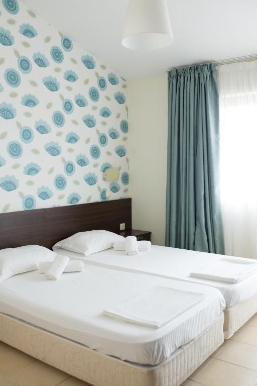Postel nebo postele na pokoji v ubytování Ema Hotel