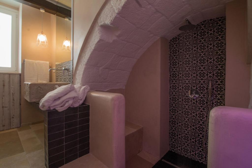 a bathroom with a sink and a shower with a towel at Casa Martina in Monopoli