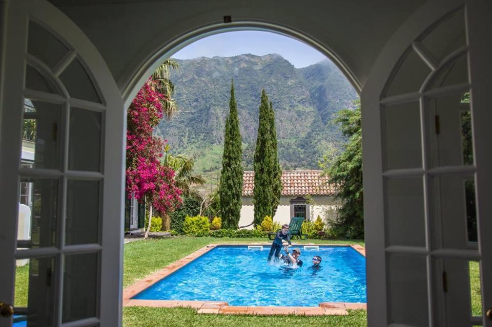 a group of people playing in a swimming pool at Casa da Portada in São Vicente