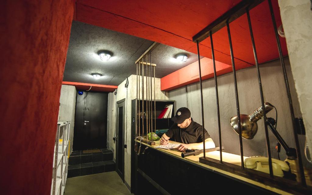 a man sitting at a counter in a kitchen at Lviv Loft Prison in Lviv