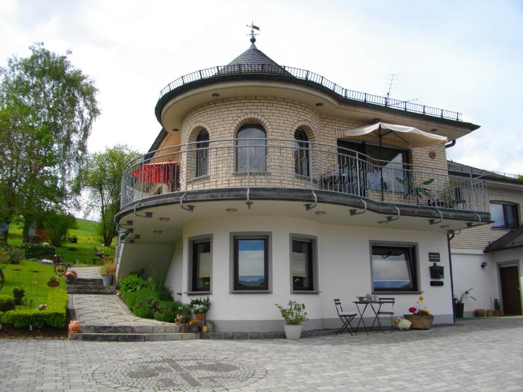 a large house with a balcony on top of it at Brigitte Karst in Kelberg