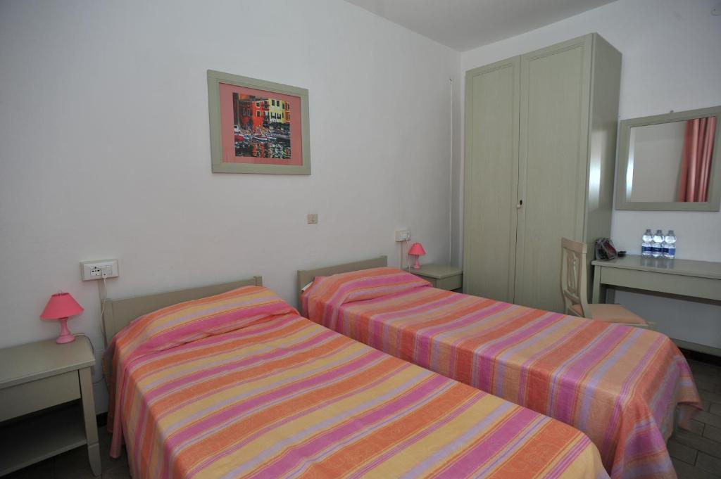 Postel nebo postele na pokoji v ubytování Albergo Dei 10 Colori