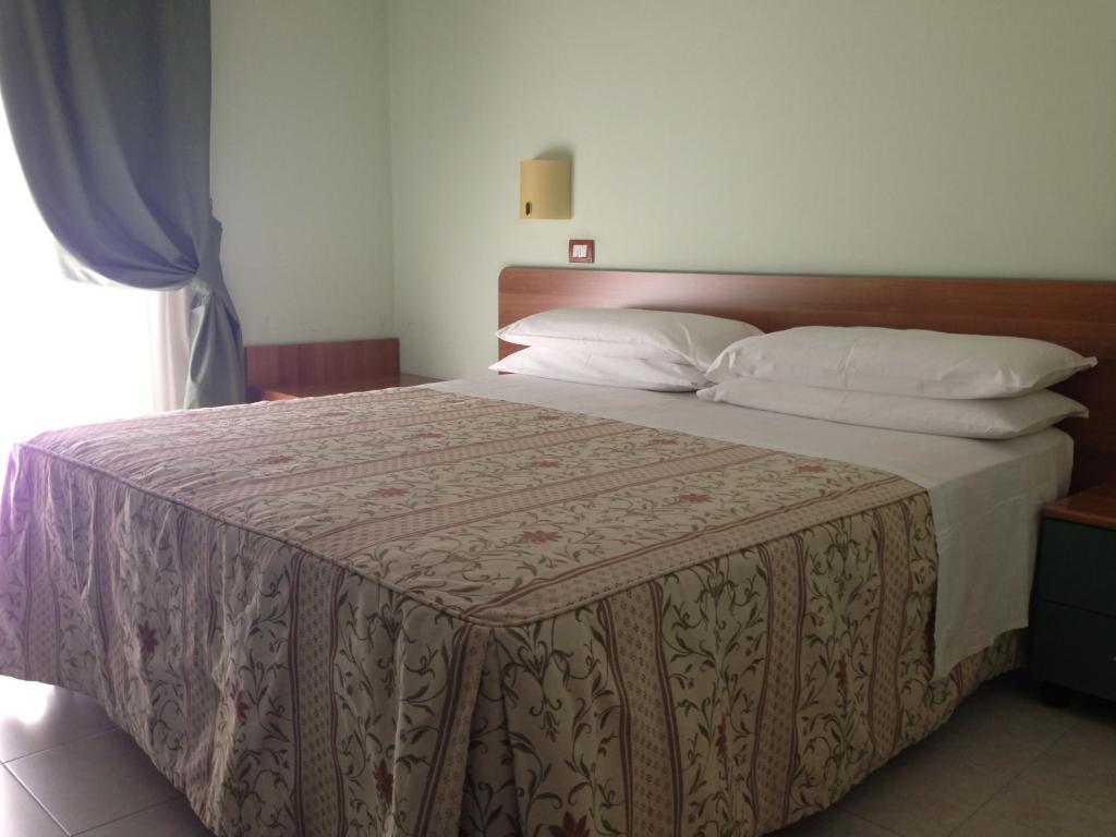 Postel nebo postele na pokoji v ubytování La Perla B&B Hotel