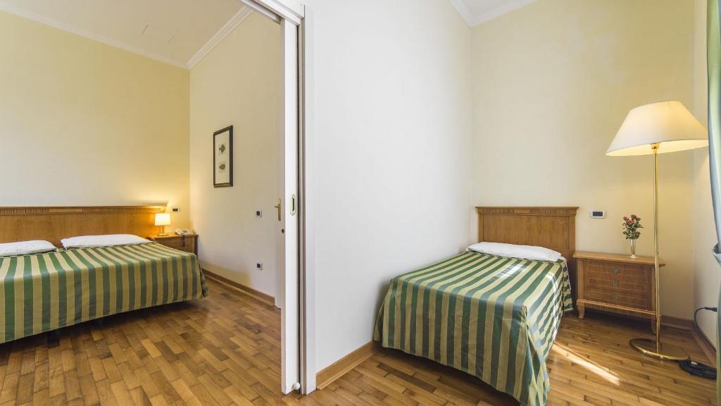 Postel nebo postele na pokoji v ubytování Hotel Ville Bianchi