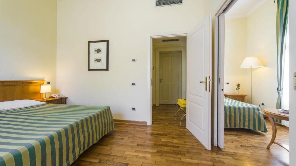 Postel nebo postele na pokoji v ubytování Hotel Ville Bianchi