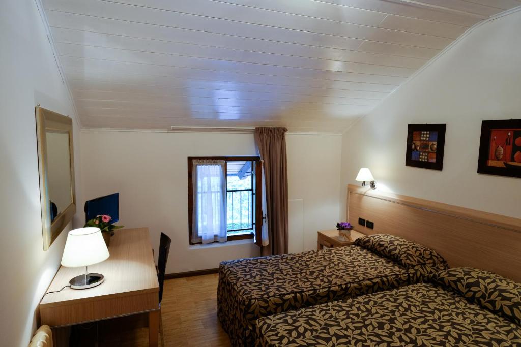 Postel nebo postele na pokoji v ubytování Hotel Monte Cimone