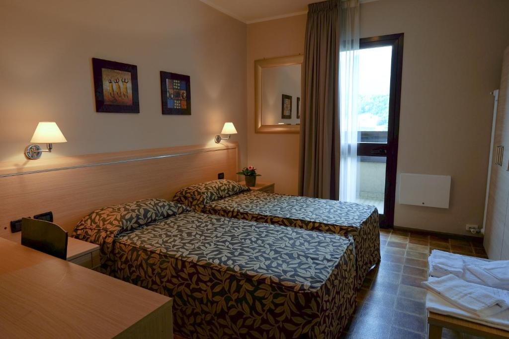 Postel nebo postele na pokoji v ubytování Hotel Monte Cimone