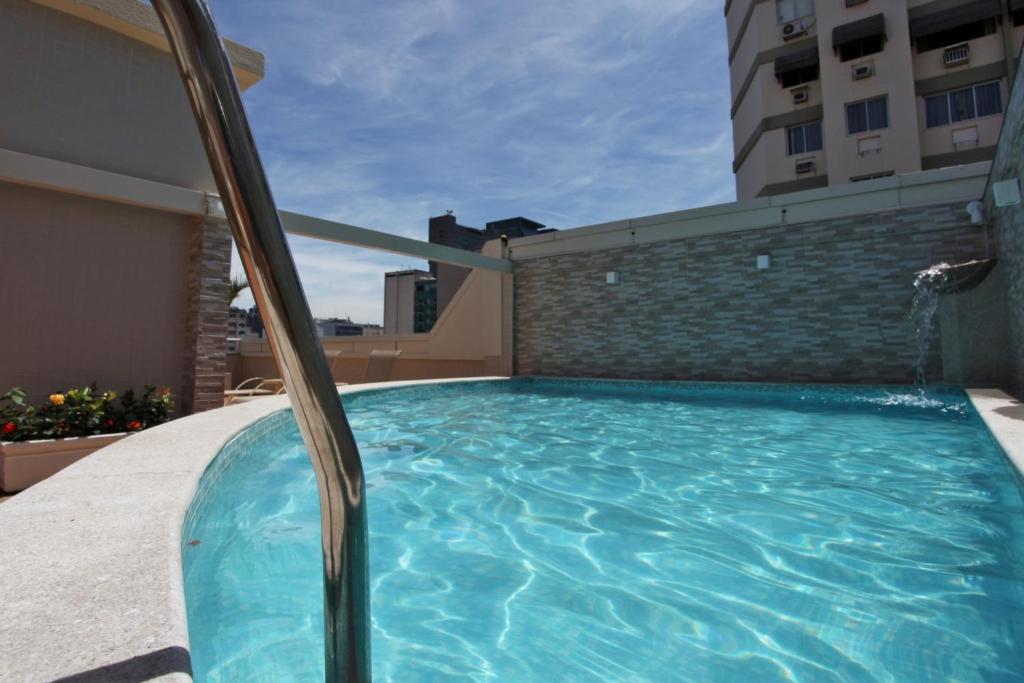 a swimming pool on the side of a building at Fluminense Hotel in Rio de Janeiro