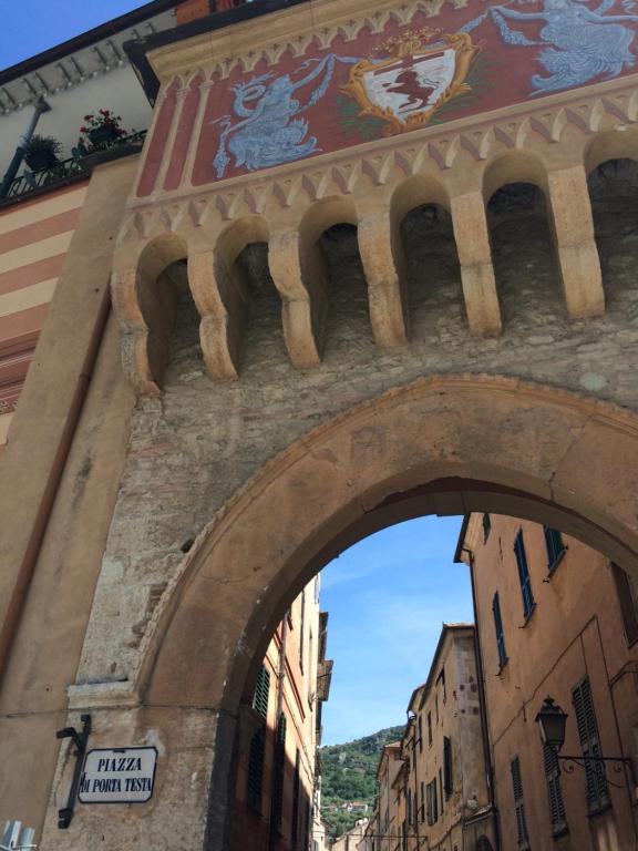 an archway over a building in a city at Koala in Finale Ligure