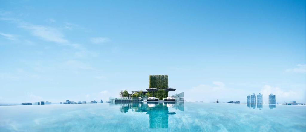 a pool of water with a building in the middle at 137 Pillars Suites Bangkok in Bangkok