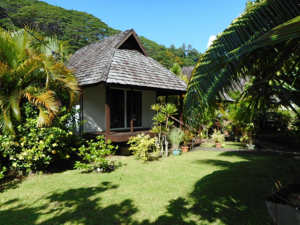 ein Haus mit einem Rasenplatz davor in der Unterkunft A Pueu Village in Pueu