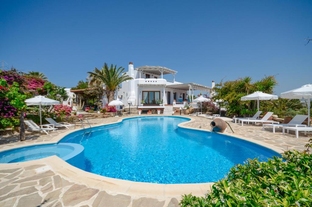 a swimming pool in front of a villa at Villa Pari Manda in Agios Prokopios