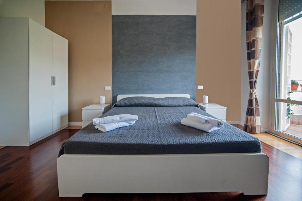 a bedroom with a bed with two towels on it at Guest House Vignola in Rome