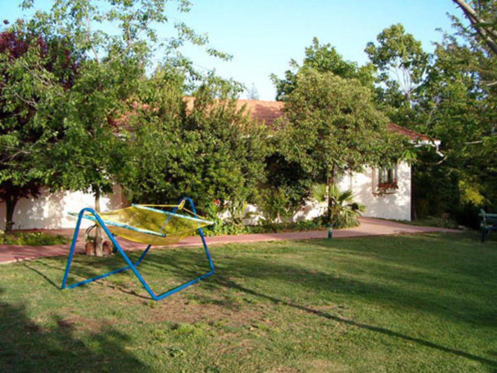 a blue and yellow swing in a yard at Bagoren in Metulla