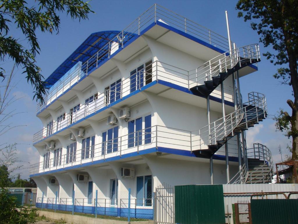 a building with blue balconies and stairs at Iceberg in Pizunda