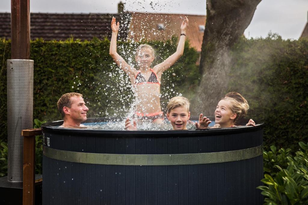 a group of people playing in a hot tub at De Rozenbottel in Tzummarum