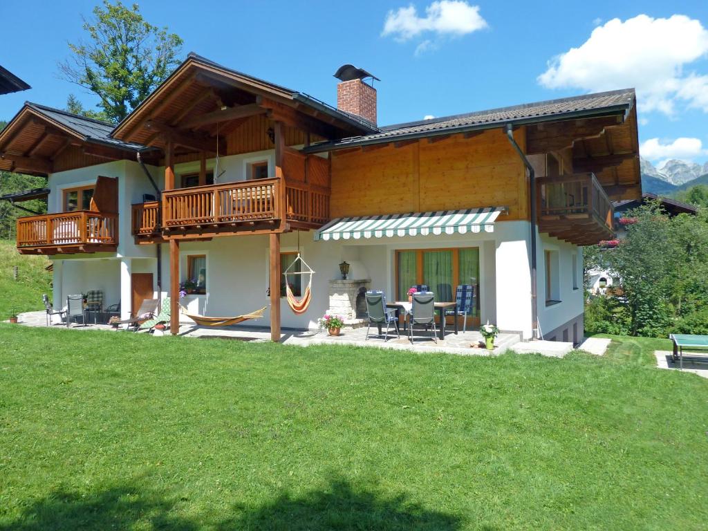 a log house with a deck and a patio at Haus Dachstein in Filzmoos