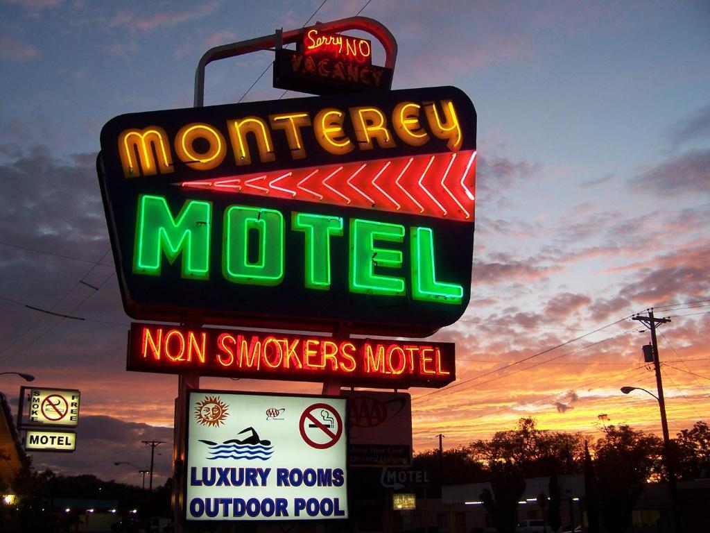 a neon sign that is on top of a pole at The Monterey Motel in Albuquerque