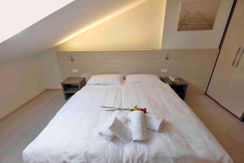 Postel nebo postele na pokoji v ubytování Hotel Gelmini