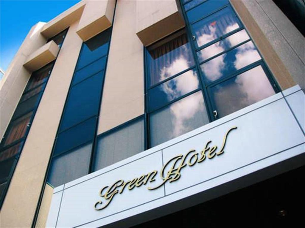 a building with a sign on the front of it at Kochi Green Hotel Harimayabashi in Kochi
