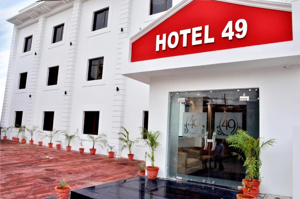 a hotel with potted plants outside of it at Hotel 49 in Amritsar