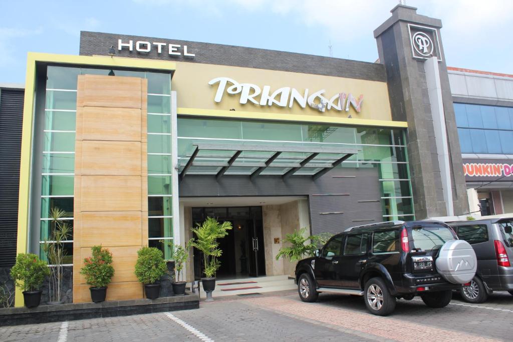 a hotel with cars parked in front of it at Hotel Priangan in Cirebon