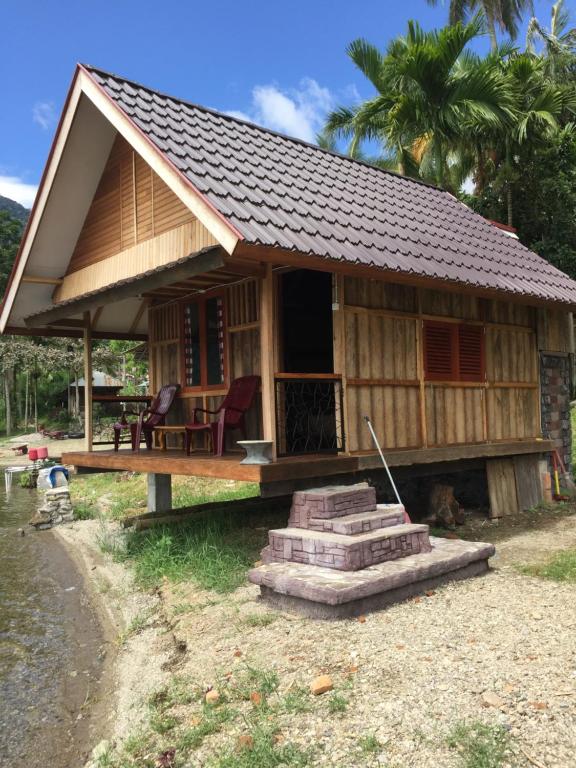 a small house with a roof on top of it at Eka's Bungalows in Maninjau