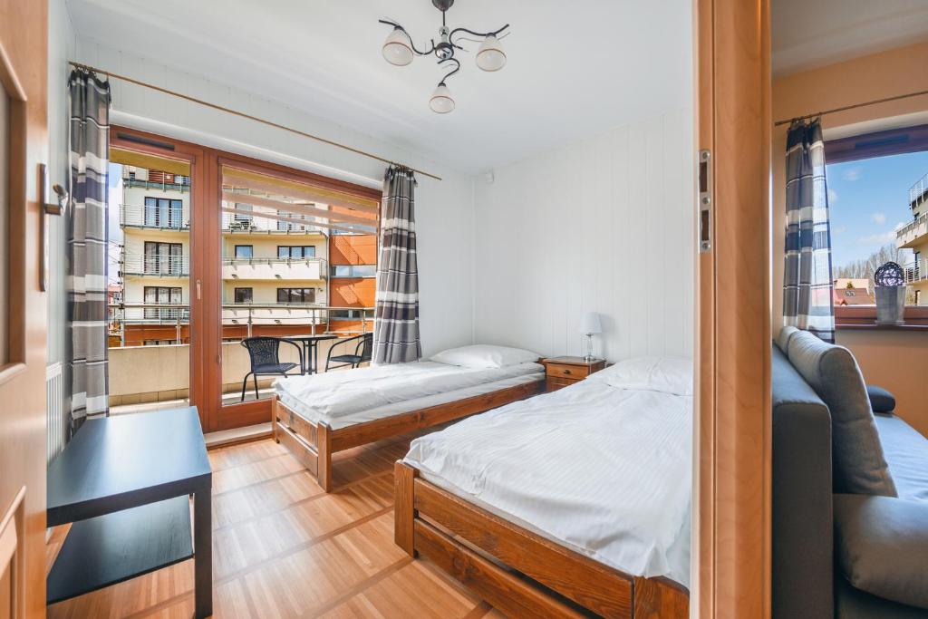Posteľ alebo postele v izbe v ubytovaní Apartamenty Sun & Snow Helska Villa - blisko plaży, blisko portu