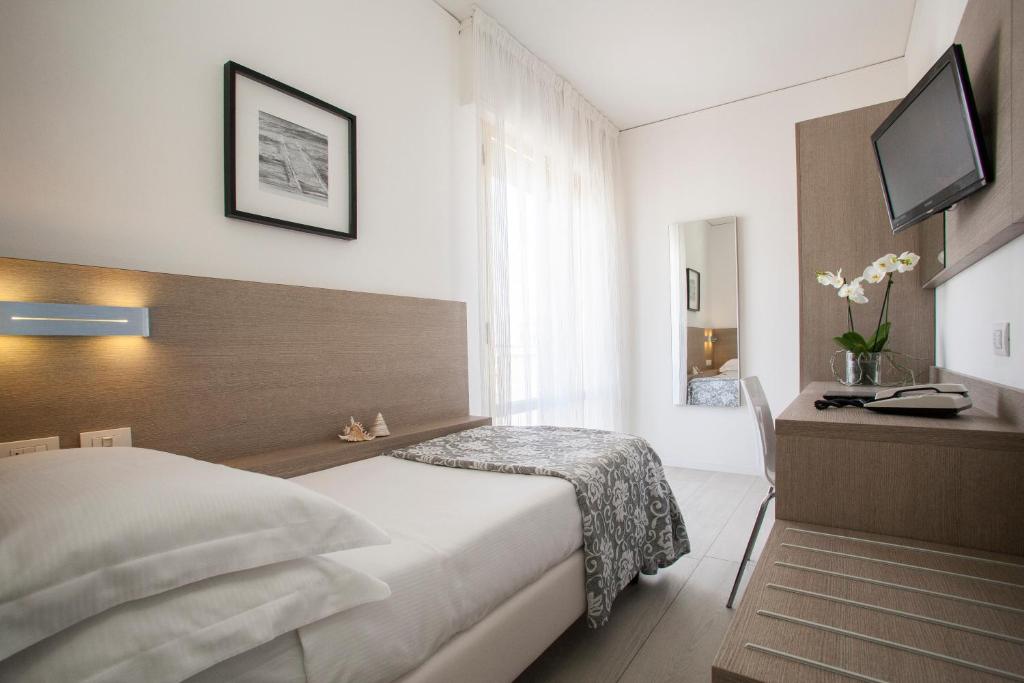 Postel nebo postele na pokoji v ubytování Hotel Imperial Palace