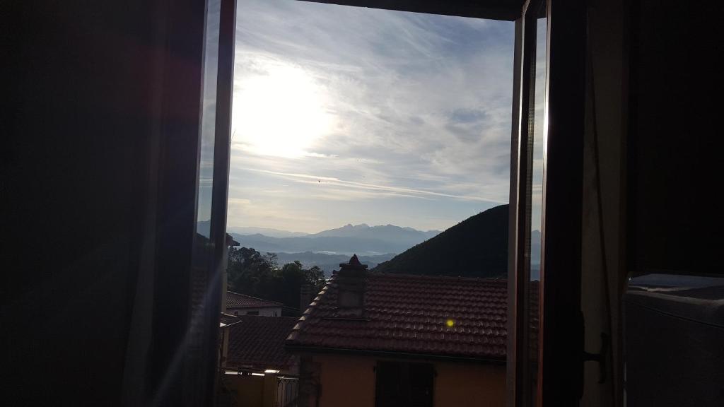 a view of the sun from a window of a building at Casa "Big Mary" cinque terre in Biassa