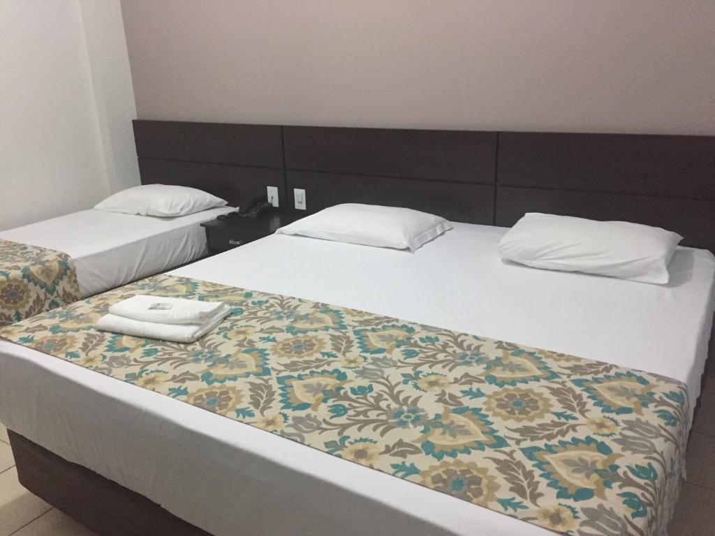 Postel nebo postele na pokoji v ubytování Hotel Notre Dame