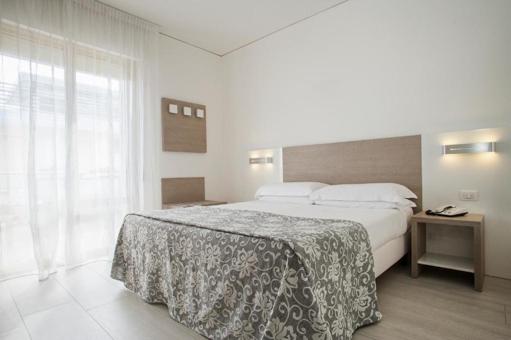 Postel nebo postele na pokoji v ubytování Hotel Imperial Palace