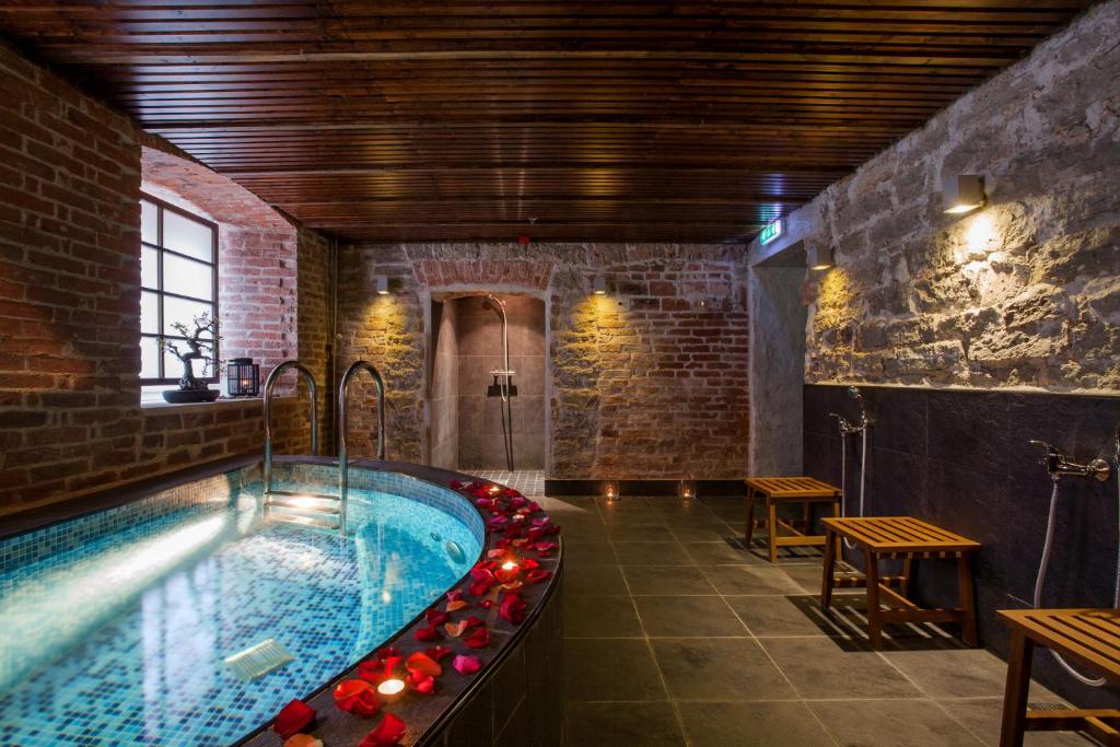 a bathroom with a hot tub in a building at City Hotel Tallinn by Unique Hotels in Tallinn