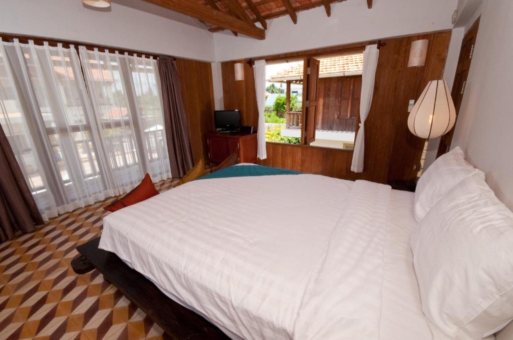 Postel nebo postele na pokoji v ubytování Bambu Hotel