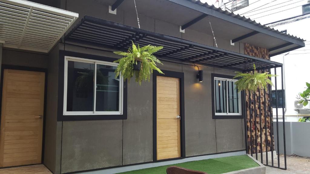 a small house with two doors and two plants at I-Talay Loft in Ko Samed