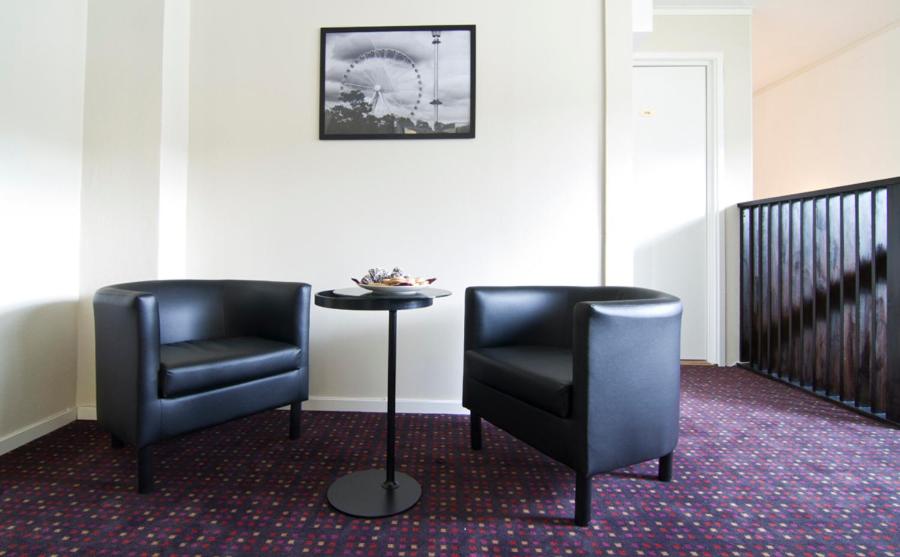 two chairs and a table in a room at Hotel & Hostel 10 in Gothenburg