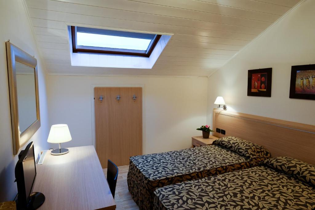 Postel nebo postele na pokoji v ubytování Hotel Monte Cimone
