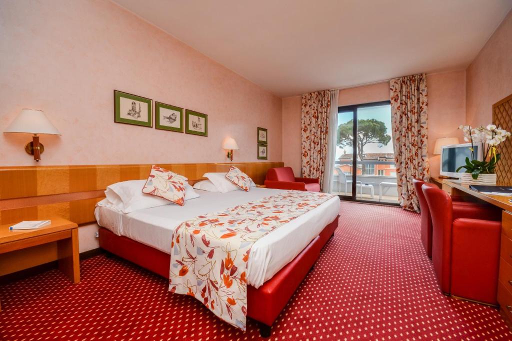 Postel nebo postele na pokoji v ubytování Hotel Oliveto