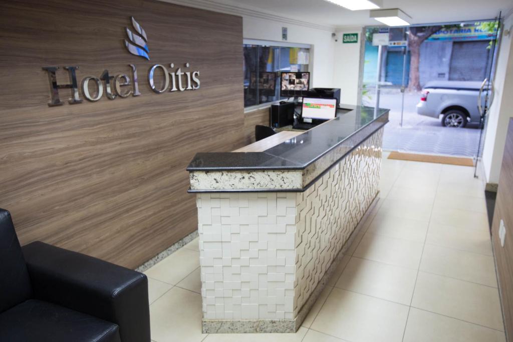 a hotel otis counter in a store with a sign on it at Hotel Oitis in Governador Valadares