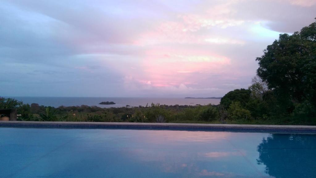 a swimming pool with a view of the ocean at El Mirador Ecológico, Ometepe in Altagracia