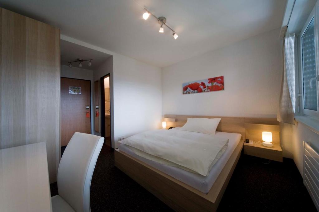 Postel nebo postele na pokoji v ubytování Hôtel Oasis