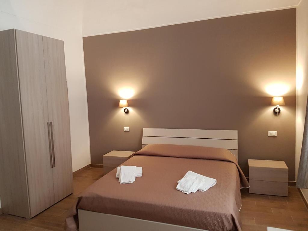 a bedroom with a bed with two towels on it at Il corso Favignana in Favignana