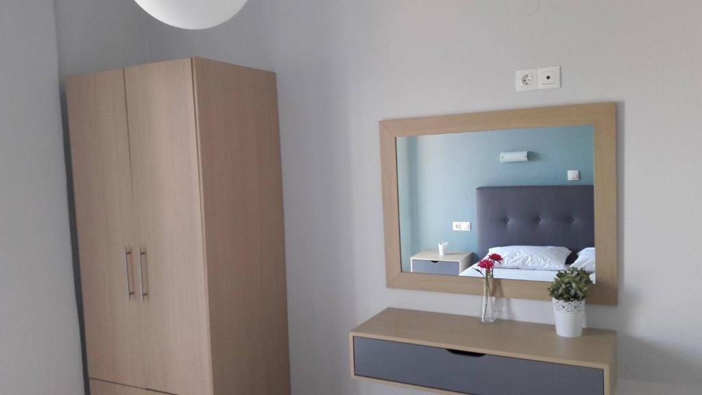 a bedroom with a large mirror and a bed at Sea Sound in Vasiliki