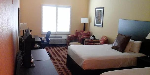a hotel room with a bed and a living room at Sagebrush Hotel in Crystal City